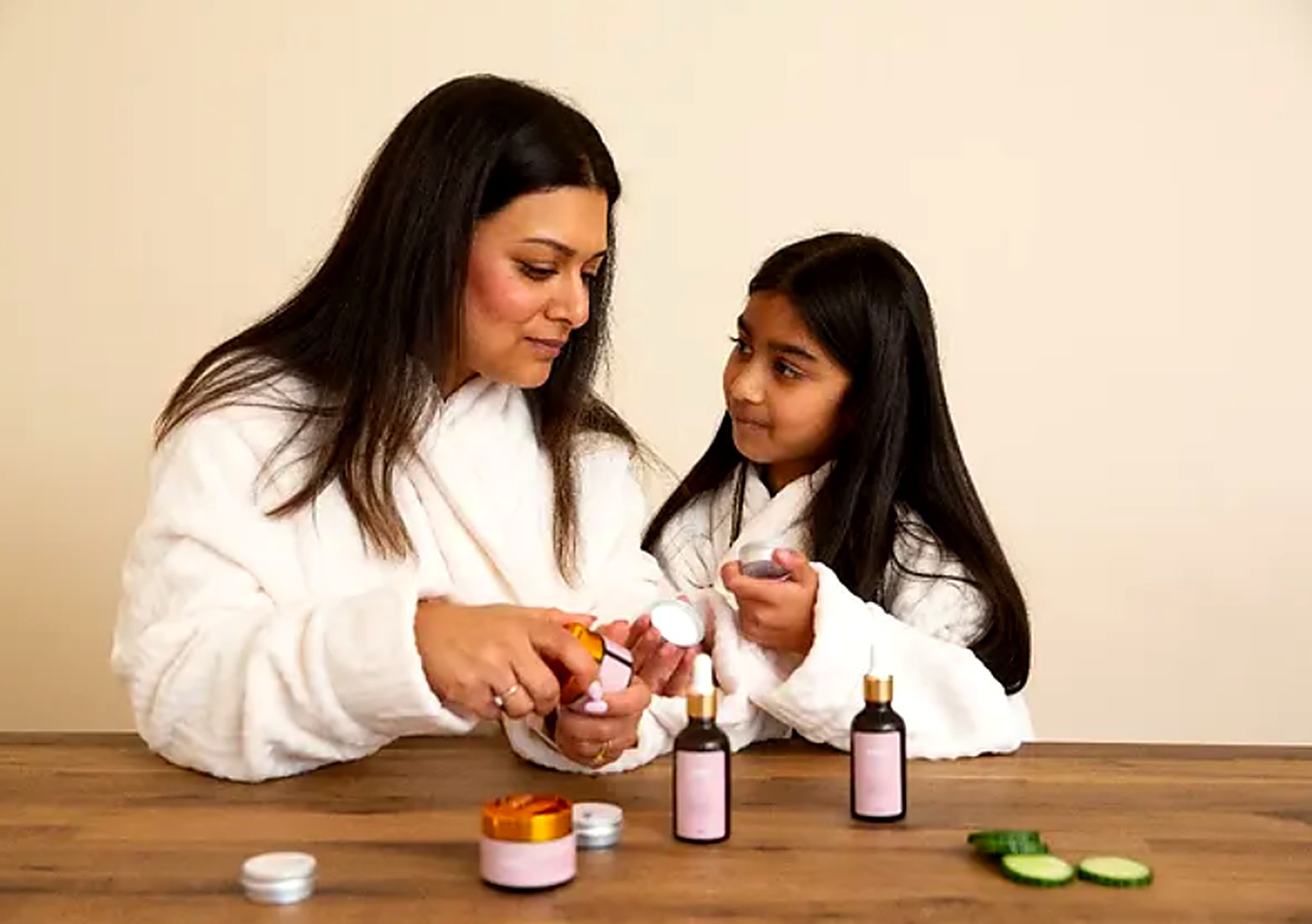 Aarti and Yana Solanki making Yani Beauty balms and serums together at a wooden table