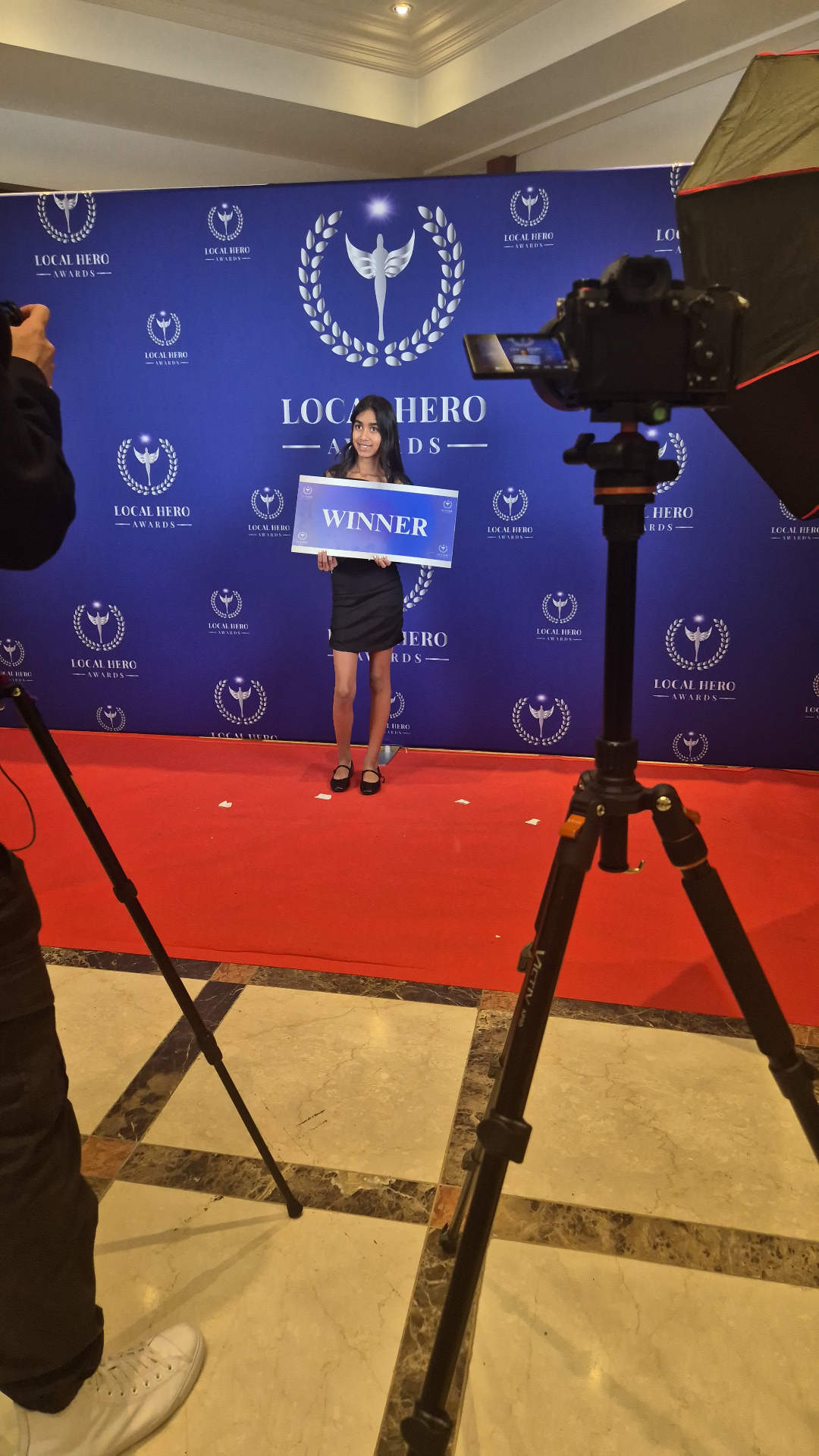 Yana Solanki on the Local Hero Awards 2026 red carpet holding her Winner board